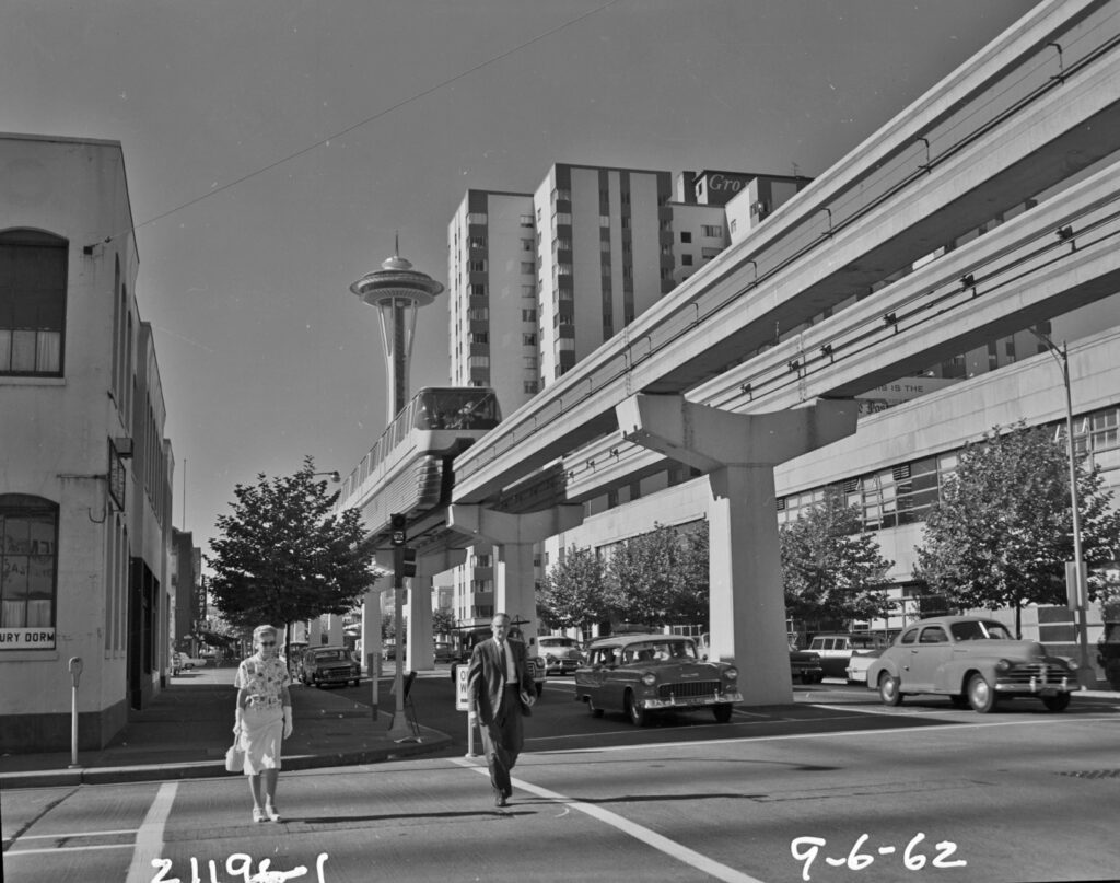 Seattle's ALWEG monorail above Fifth Avenue with the Space Needle in the distance, 1962.